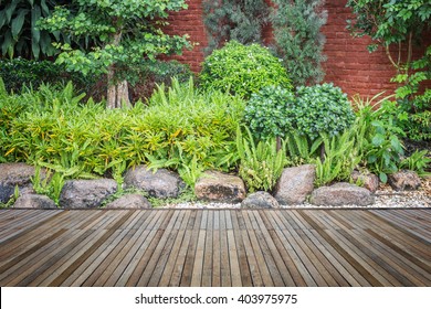 Old hardwood decking or flooring and plant in garden decorative - Shutterstock ID 403975975