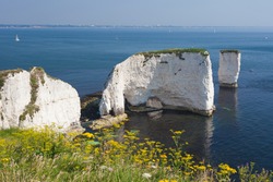 The Old Harry Rocks Are Chalk Formations, Located At Handfast Point, On The Isle Of Purbeck In Dorset, Southern England. (With Bournemouth In The Background)