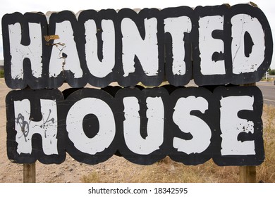 Old Haunted House Sign On The Side Of A Road.