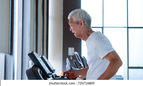 Old Healthy Asian Senior Couple Exercise Together In Gym Running Treadmill