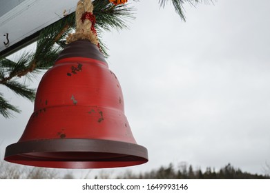 Old Heavy Metal Red Bell Hanging As A Christmas Decoration Outside A House.