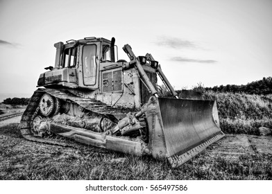 Old heavy and rusty bulldozer is strong worker in building.