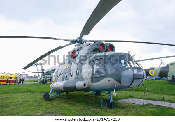 Old helicopter\
Mi-8T standing on a field, made in USSR. Festival OLD CAR Land. May\
12, 2019. Kiev, Ukraine