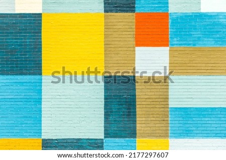 old historic brick wall painted in rainbow colors