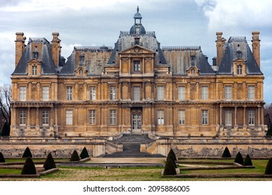 Old historic Chateau Maison or Chateau Maison-Laffitte in the suburbs of Paris in cloudy weather. Facade of the famous 17th century castle in Maison Lafitte on rainy spring day. Yvelines, France, 