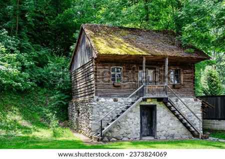 An old historic house made with wood and stones in a rural area in Romania
