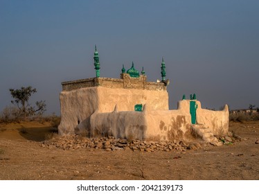 an old historical mosque in the desert,mud made old  mosque in the rohi desert punjab pakistan 