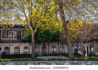 Old historical stone houses. The trees pass the house, the house is behind the trees. - Powered by Shutterstock