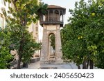 Old Historical Water tower with tangerine trees onthe foreground in Rishon Lezion, Israel. City landmark.