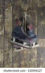 Old Hockey Skates On Background Of Wood