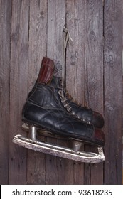 Old Hockey Skates On Background Of Wood