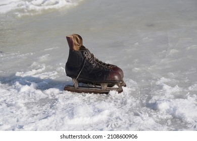 Old Hockey Skates On Ice Background