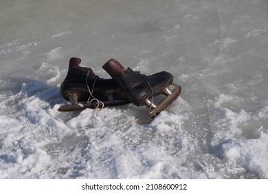 Old Hockey Skates On Ice Background