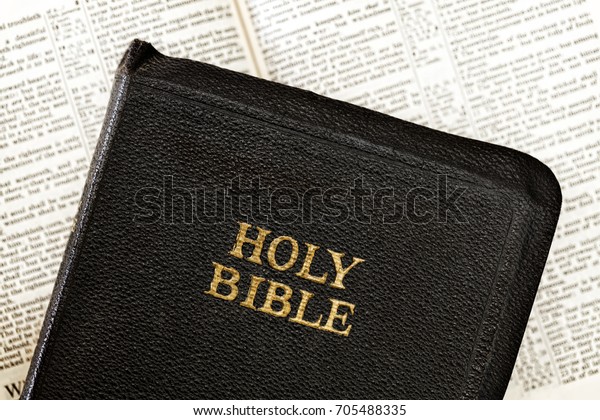 Old Holy Bible over blurred open book.