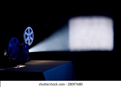 Old Home Film Projector, Running And Projecting Blank Movie On A Screen With Visible  Beam Of Light