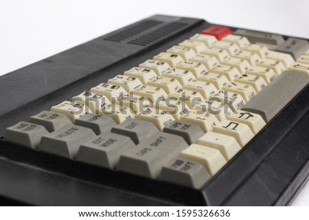 Old home keyboard with red button. Isolate on white.