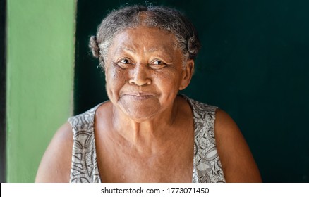 Old homeless indigenous, with happy face and blue eyes
