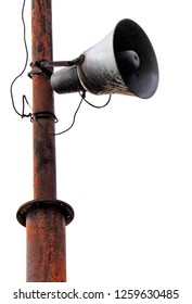 Old horn fixed on iron rustic pole isolated on a white background. Megaphone, speaker, siren.