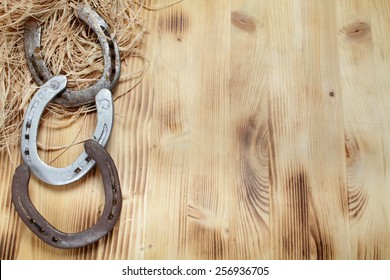 Old horseshoe on a wooden board