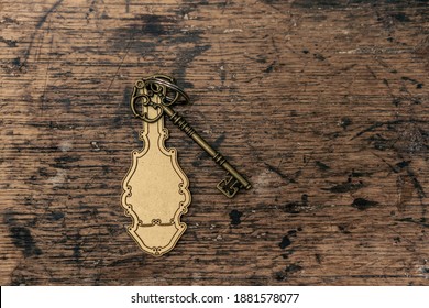 Old Hotel Key With A Vintage Keychain Mockup. Key Laying On Chabby Wooden Table, Or A Reception Desk.