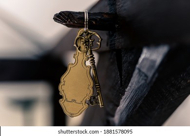 Old Hotel Key With A Vintage Keychain Mockup Hanging On A Timber Bar.