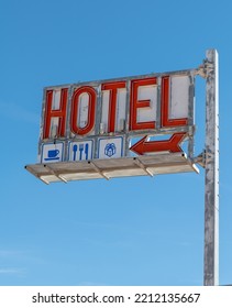 Old Hotel Sign Against The Blue Sky