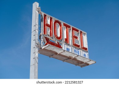 Old Hotel Sign Against The Blue Sky