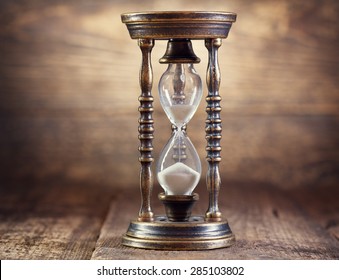 Old Hourglass On Wooden Background