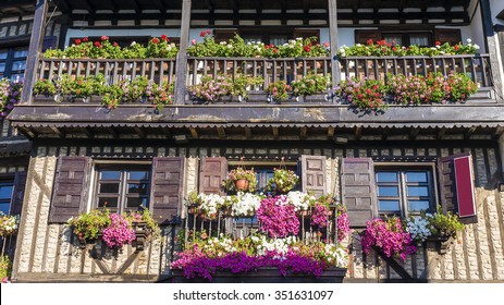 an old house with a balcony decorated with flowers