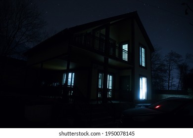 Old house with a Ghost in the forest at misty night or Night scene with House under moon. Old mystic building in dead tree forest. - Powered by Shutterstock