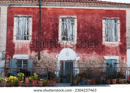 An old house painted with red flower paint in Zakynthos, Greece