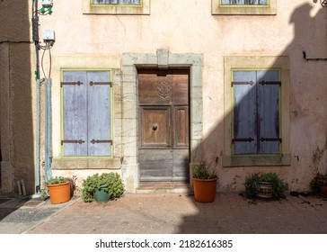 Old House Of The Village Of Gruissan With Blue Shutters, Southern France, With Stone, Beige Colored Walls And Blue Shutters, Taken On A Sunny Winter Afternoon With No People