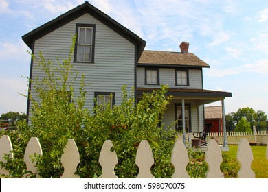 Old house with a white picket fence