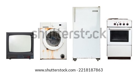 Old household appliances TV, washing machine, refrigerator, electric stove isolated on white background.