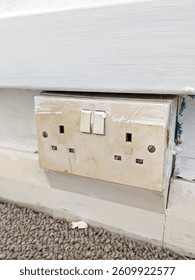 An old household plug socket that could be dangerous and need replacing DIY renovation