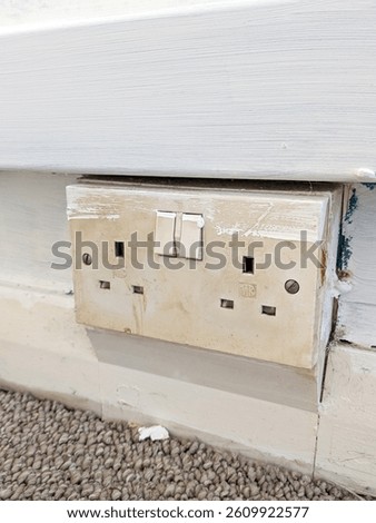 An old household plug socket that could be dangerous and need replacing DIY renovation