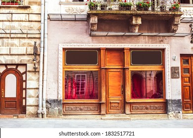 Old Houses And Closed Window Shop At Market Square In Lviv, Ukraine. Wooden Shopfront In Summer Town