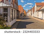 Old houses on cobbled street at the old town of Aabenraa, Denmark