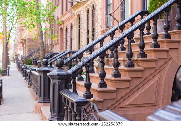 Old houses with stairs in the historic district\
of West Village