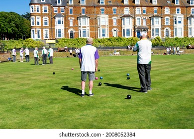 Old Hunstanton, Norfolk, England - June 13, 2021. Two Men On Their Back Playing The Lawn Bowls.