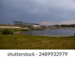 An old hydropower plant that flows into the river and all around is green nature