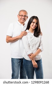 old Indian father with young girl standing isolated over white background