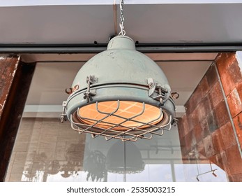 Old industrial antique lamp. Vintage industrial hanging lamps are used for decorating dining areas, hotel rooms, or youth clothing stores. - Powered by Shutterstock