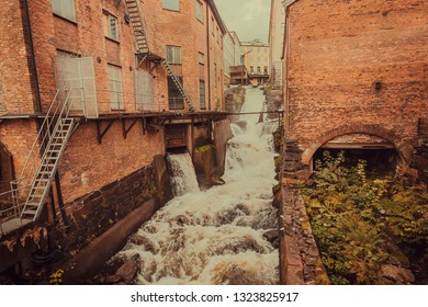Old industrial area with factories and wWater stream of a small waterfall in Gothenburg, Sweden.