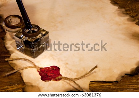 Old ink pot on a parchment scroll with wax seal