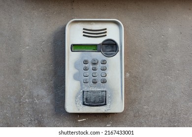 Old intercom with camera for video call mounted on a concrete wall