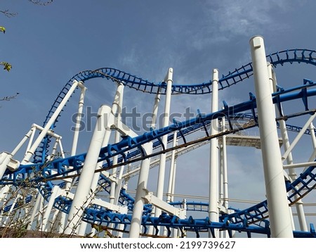 Old inverted roller coaster painted in blue and white