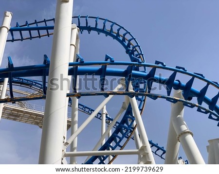 Old inverted roller coaster painted in blue and white