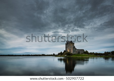 Old Irish Dunguaire Castle near the water in the evening with reflection
