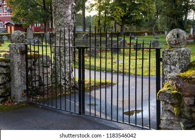 Old Iron Gate To A Cemetery. Taken On A Sunny Autumn Day In Sweden
